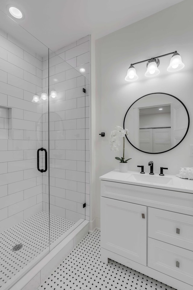 bathroom with a shower with door and vanity