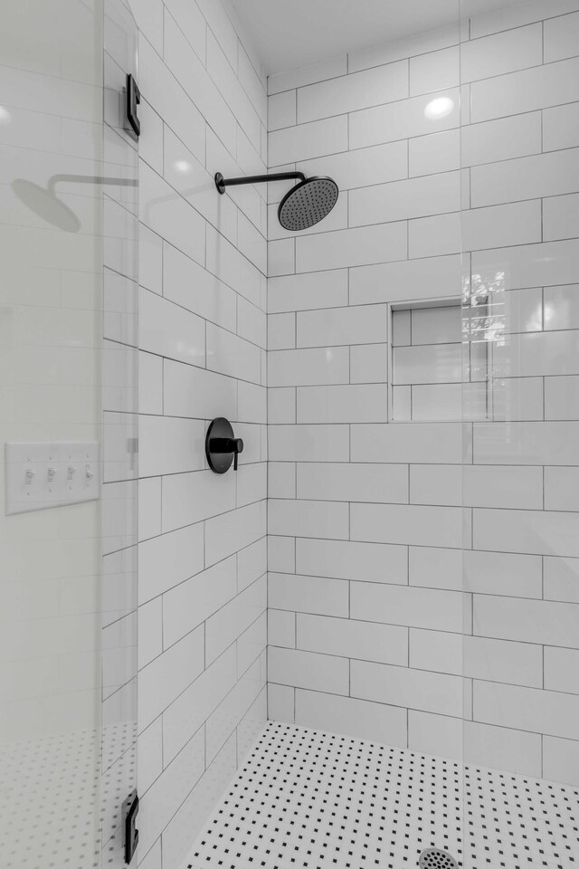 bathroom with a tile shower