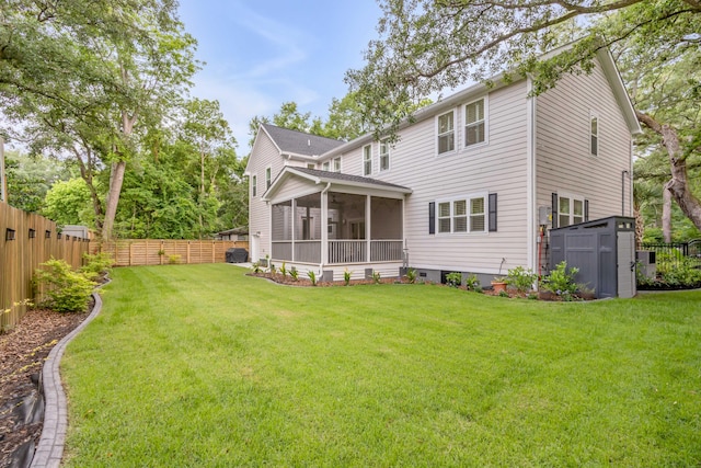 back of property featuring a lawn and a sunroom