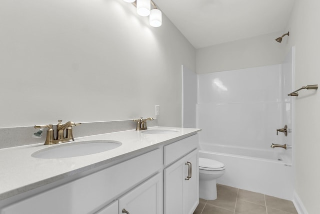 bathroom featuring tile patterned floors, a sink, double vanity, and toilet