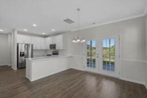 kitchen featuring dark wood-style flooring, stainless steel fridge, a peninsula, and white cabinetry