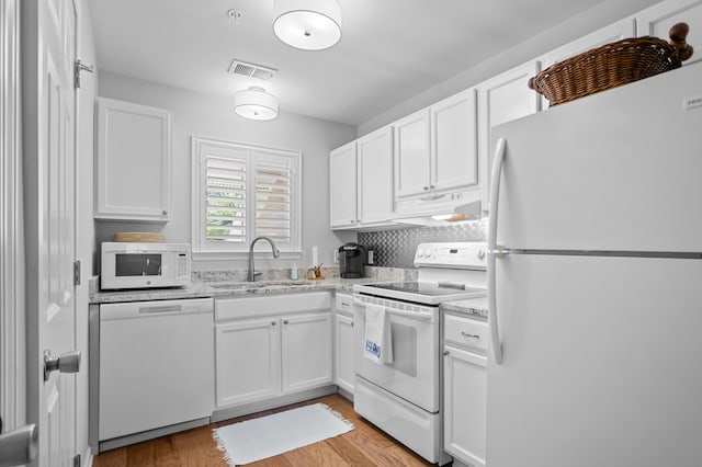 kitchen featuring visible vents, white appliances, white cabinetry, and under cabinet range hood