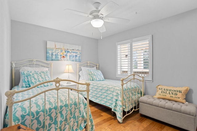 bedroom with ceiling fan and wood finished floors