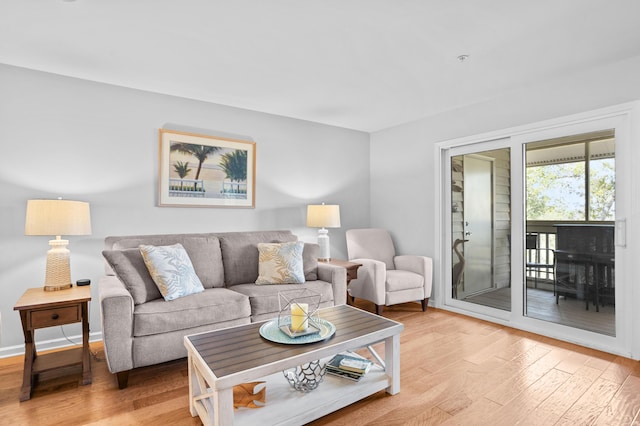 living room with light wood finished floors and baseboards