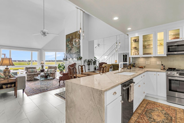 kitchen featuring white cabinetry, ceiling fan, appliances with stainless steel finishes, and kitchen peninsula