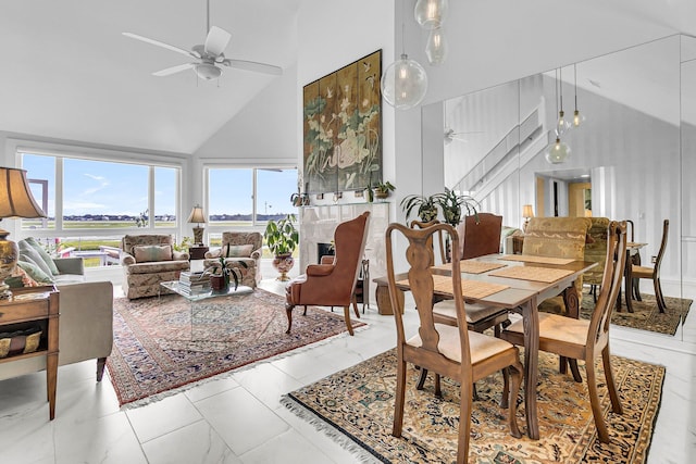 dining room featuring ceiling fan and high vaulted ceiling