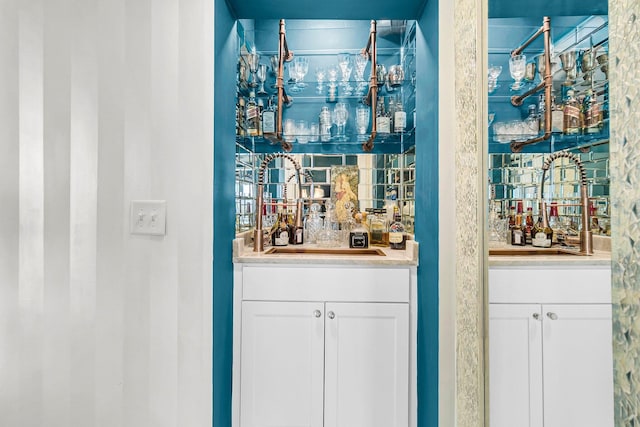 bar with sink and white cabinets