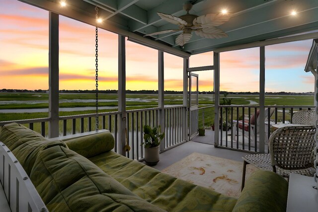 sunroom featuring a wealth of natural light and ceiling fan