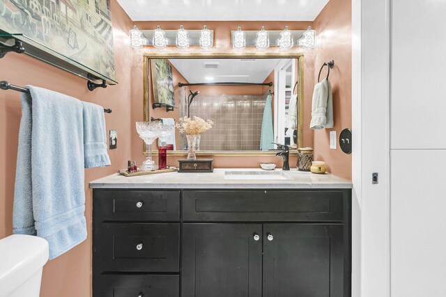 bathroom featuring vanity, toilet, and curtained shower