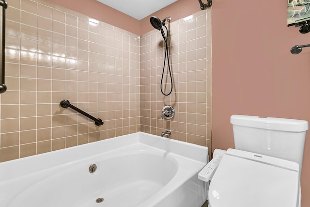 bathroom with toilet and tiled shower / bath combo