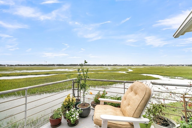 balcony featuring a rural view and a water view