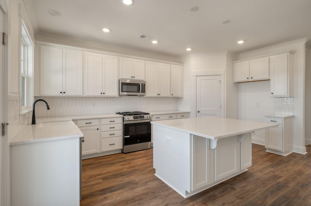 414 Katies Scenic Ct, Charleston, SC 29492 - kitchen featuring a center island, stainless steel appliances, backsplash, white cabinetry, and visible vents