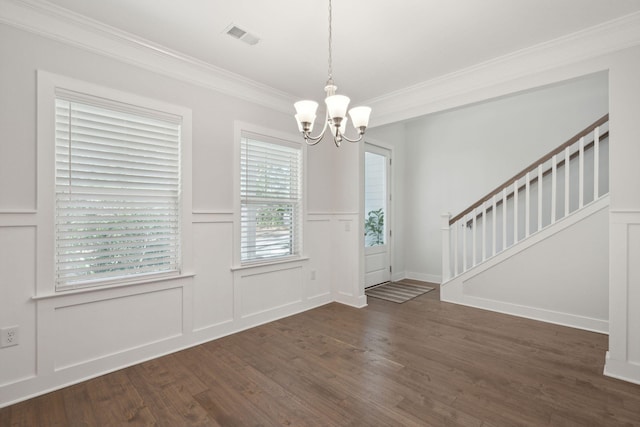 entrance foyer with ornamental molding, dark hardwood / wood-style flooring, and a notable chandelier