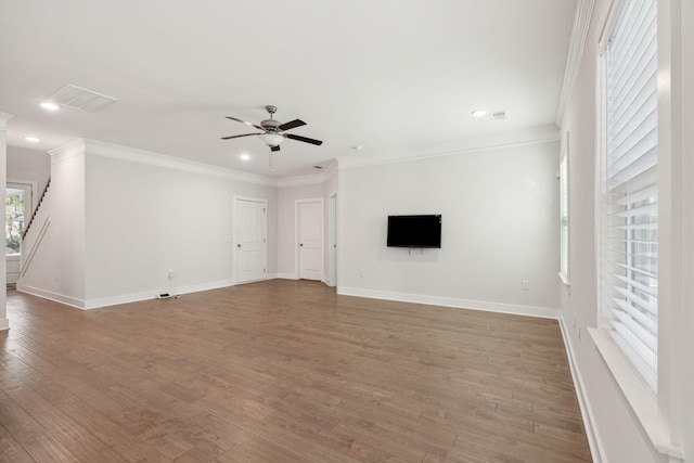 unfurnished living room featuring ceiling fan, ornamental molding, and wood-type flooring