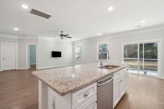 kitchen with sink, white cabinetry, ornamental molding, a center island with sink, and stainless steel dishwasher