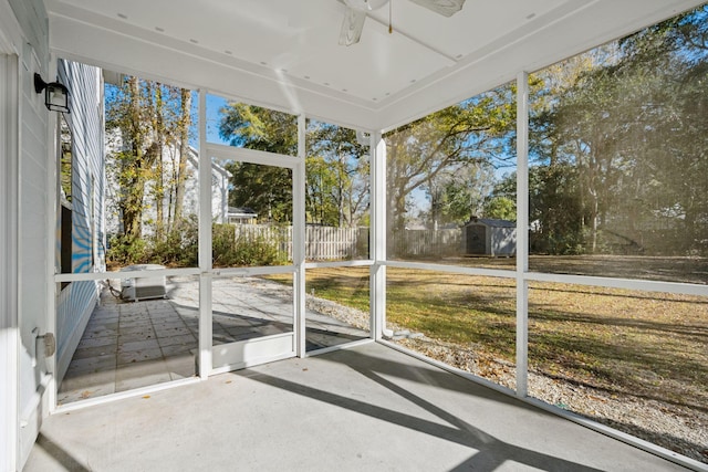 unfurnished sunroom featuring ceiling fan