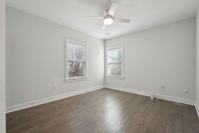 empty room featuring ceiling fan and dark hardwood / wood-style floors