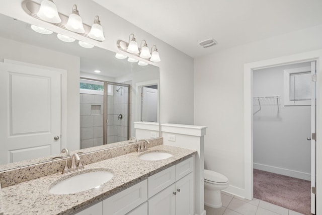 bathroom featuring vanity, an enclosed shower, tile patterned floors, and toilet