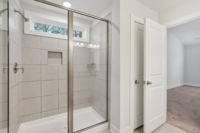 bathroom featuring an enclosed shower and tile patterned floors