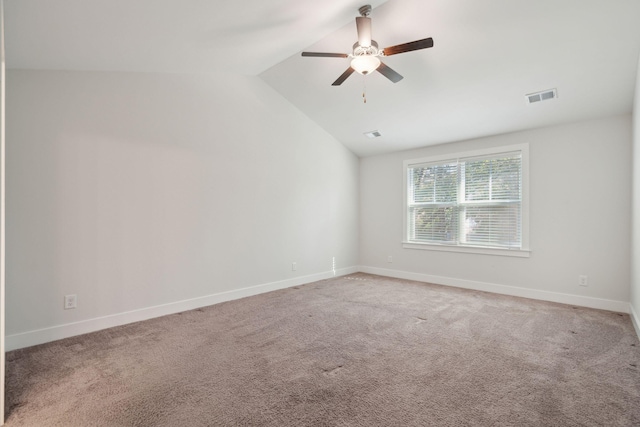 spare room with carpet floors, vaulted ceiling, and ceiling fan