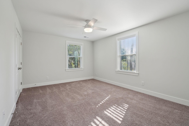 carpeted spare room with ceiling fan