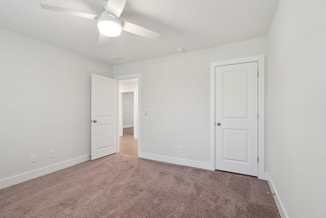 unfurnished room with ceiling fan and carpet flooring