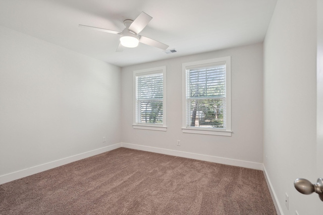 carpeted spare room featuring ceiling fan