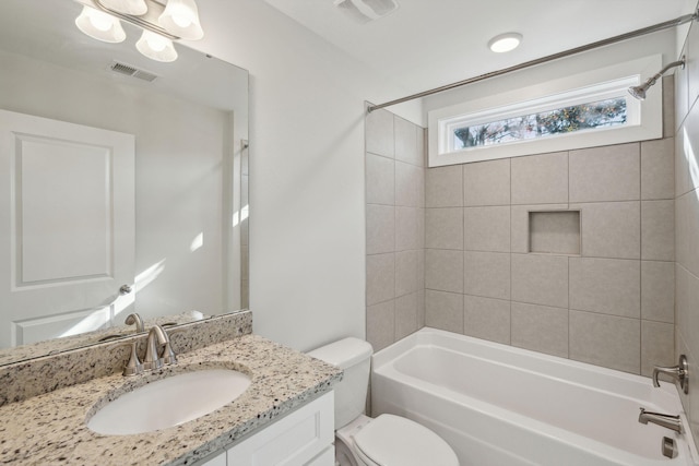 full bathroom with vanity, toilet, and tiled shower / bath combo