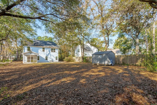 view of yard with a storage shed and a sunroom