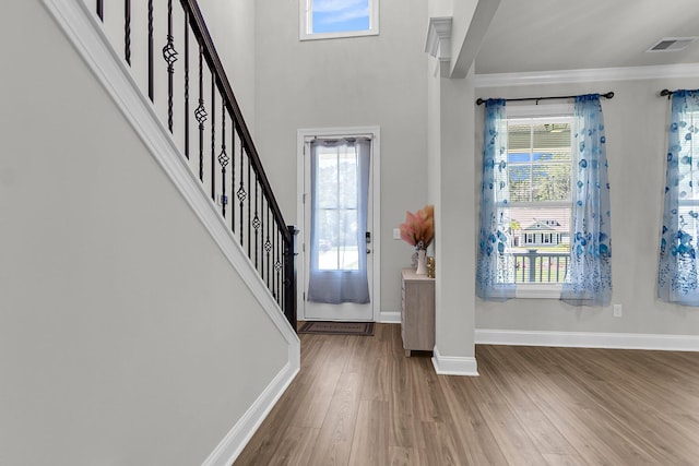 404 Bowstring Dr, Huger, SC 29450 - foyer with crown molding, wood finished floors, baseboards, and stairway