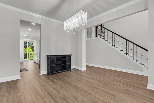 404 Bowstring Dr, Huger, SC 29450 - unfurnished living room featuring wood finished floors, a chandelier, baseboards, stairs, and ornamental molding