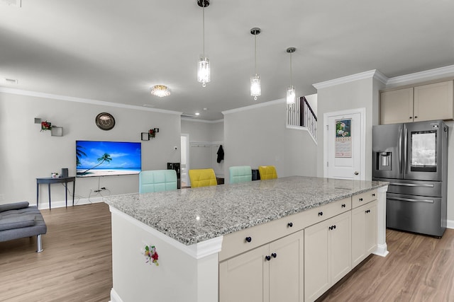 404 Bowstring Dr, Huger, SC 29450 - kitchen with stainless steel fridge, light wood-style floors, ornamental molding, light stone countertops, and baseboards