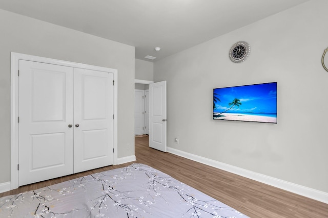 404 Bowstring Dr, Huger, SC 29450 - bedroom with wood finished floors, baseboards, and a closet