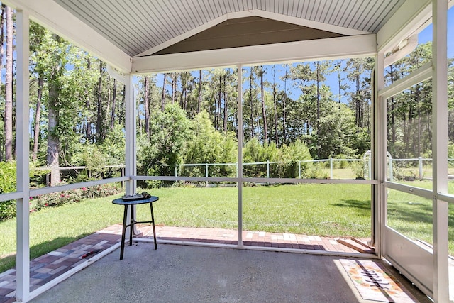 404 Bowstring Dr, Huger, SC 29450 - unfurnished sunroom featuring lofted ceiling and view of scattered trees