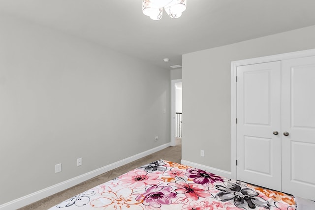 404 Bowstring Dr, Huger, SC 29450 - bedroom featuring light carpet, baseboards, a closet, and a chandelier