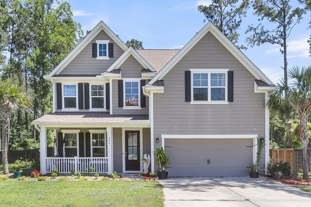 404 Bowstring Dr, Huger, SC 29450 - traditional home featuring covered porch, an attached garage, driveway, and a shingled roof