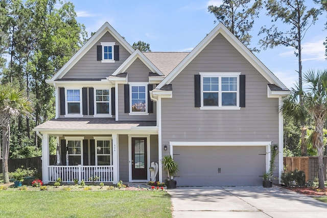 404 Bowstring Dr, Huger, SC 29450 - traditional home with a porch, a garage, driveway, and a shingled roof