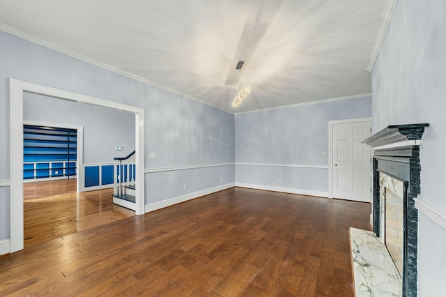 1560 NW Lee Blvd, Orangeburg, SC 29118 - unfurnished living room with dark wood-style floors, a fireplace with raised hearth, ornamental molding, and stairway