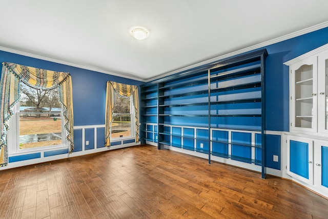 1560 NW Lee Blvd, Orangeburg, SC 29118 - unfurnished room with a wainscoted wall, wood finished floors, crown molding, and a decorative wall