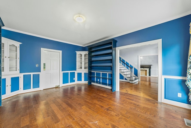 1560 NW Lee Blvd, Orangeburg, SC 29118 - unfurnished room featuring hardwood / wood-style floors, stairway, visible vents, and ornamental molding