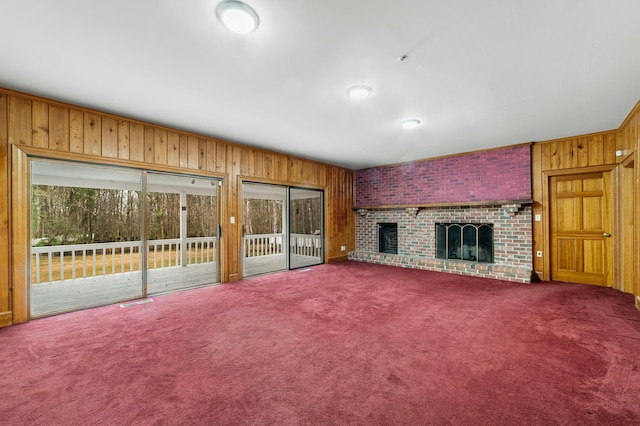 1560 NW Lee Blvd, Orangeburg, SC 29118 - unfurnished living room with a brick fireplace, carpet flooring, and wood walls