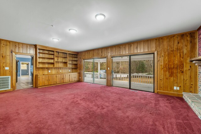 1560 NW Lee Blvd, Orangeburg, SC 29118 - unfurnished living room featuring wooden walls, visible vents, and carpet floors
