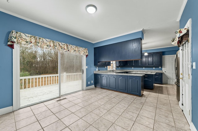 1560 NW Lee Blvd, Orangeburg, SC 29118 - kitchen featuring light tile patterned floors, visible vents, baseboards, light countertops, and crown molding