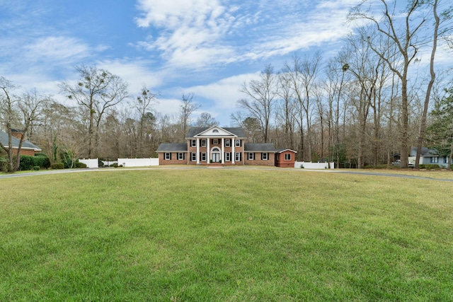 view of front of home with a front yard and fence