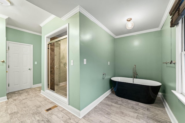 1560 NW Lee Blvd, Orangeburg, SC 29118 - full bath featuring baseboards, visible vents, a freestanding tub, ornamental molding, and a shower stall
