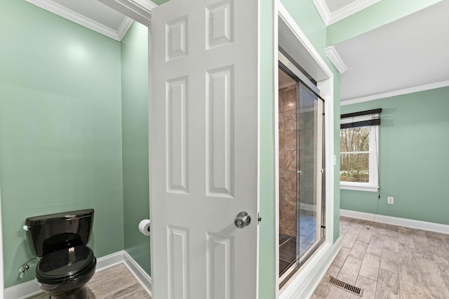 1560 NW Lee Blvd, Orangeburg, SC 29118 - bathroom with visible vents, toilet, ornamental molding, wood finished floors, and baseboards