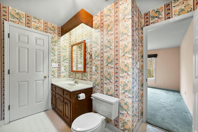 1560 NW Lee Blvd, Orangeburg, SC 29118 - bathroom with tile patterned floors, toilet, wallpapered walls, baseboards, and vanity
