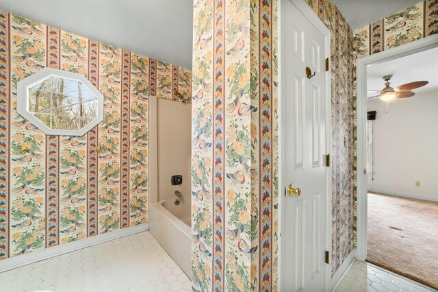 1560 NW Lee Blvd, Orangeburg, SC 29118 - bathroom featuring tile patterned flooring, a bathtub, baseboards, and wallpapered walls