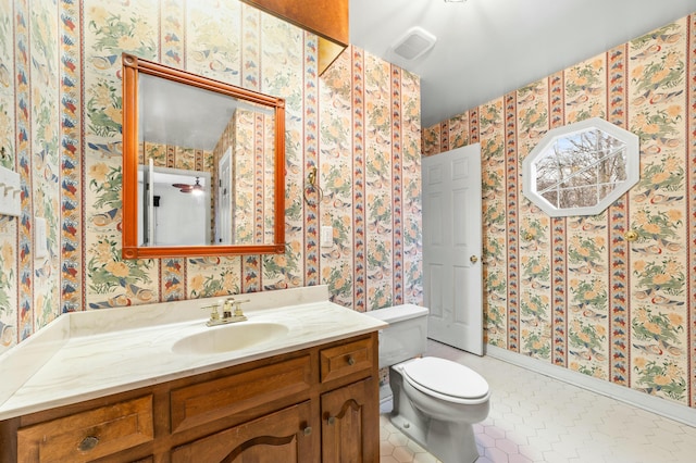 1560 NW Lee Blvd, Orangeburg, SC 29118 - bathroom featuring tile patterned flooring, visible vents, wallpapered walls, toilet, and vanity