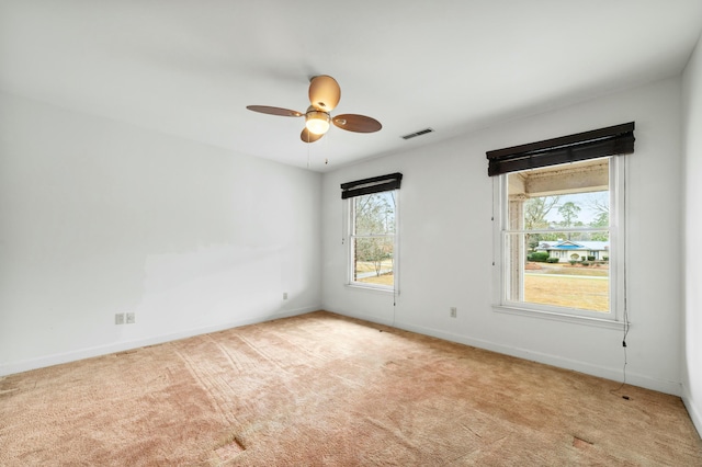 1560 NW Lee Blvd, Orangeburg, SC 29118 - spare room with light carpet, visible vents, a ceiling fan, and baseboards